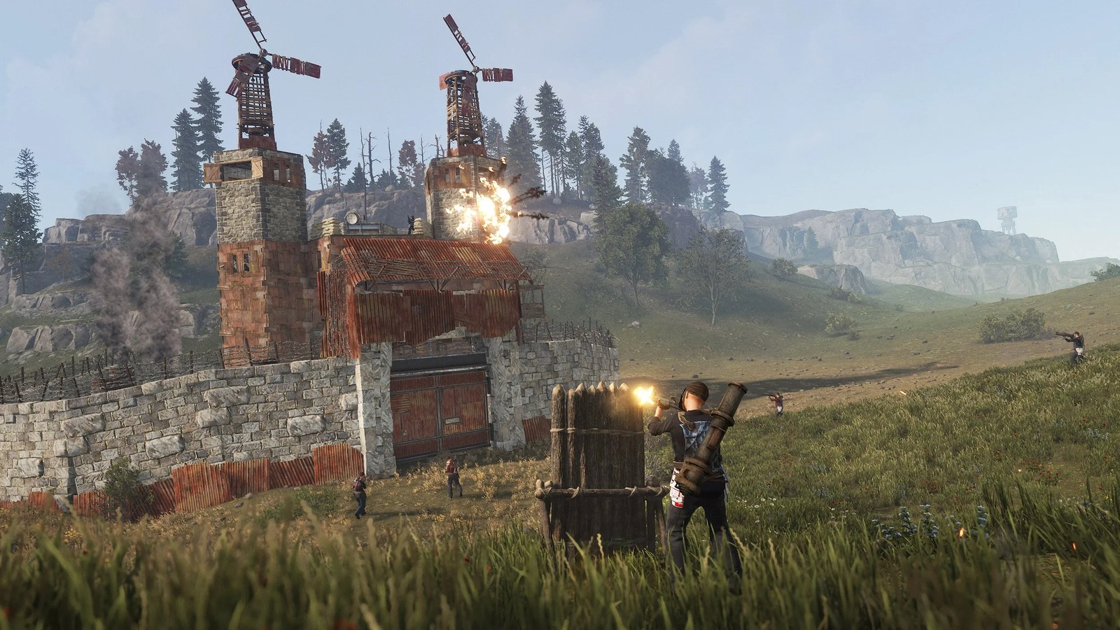 Players raiding a Rust compound with rockets and rifles